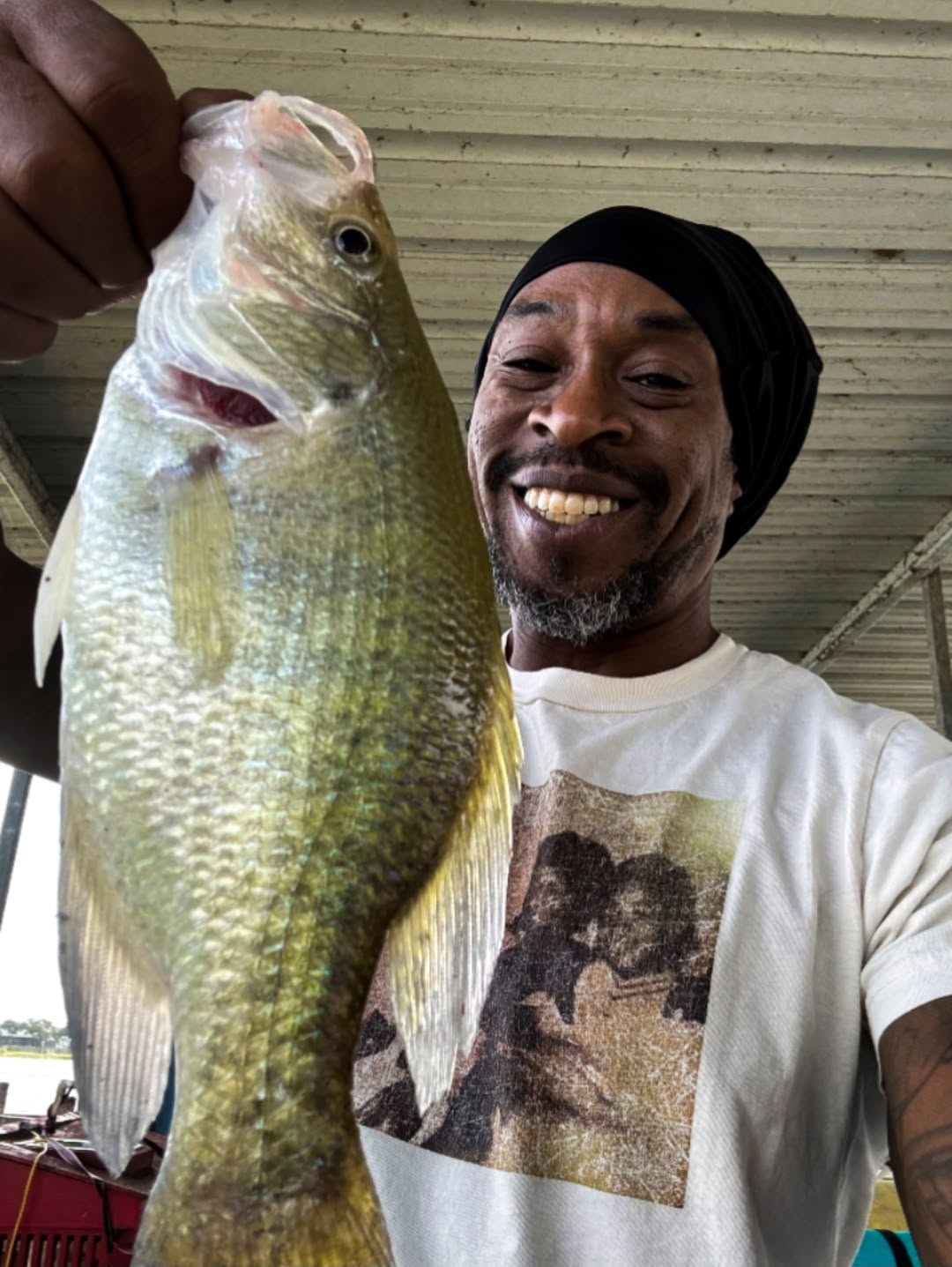 A bass held up off the side of a boat