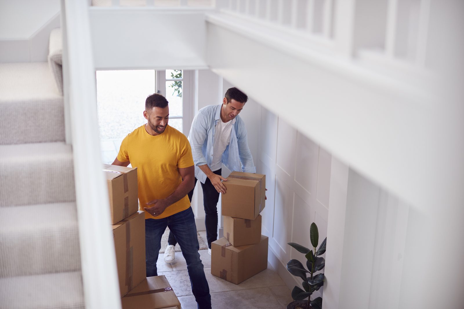 Dads carrying moving boxes